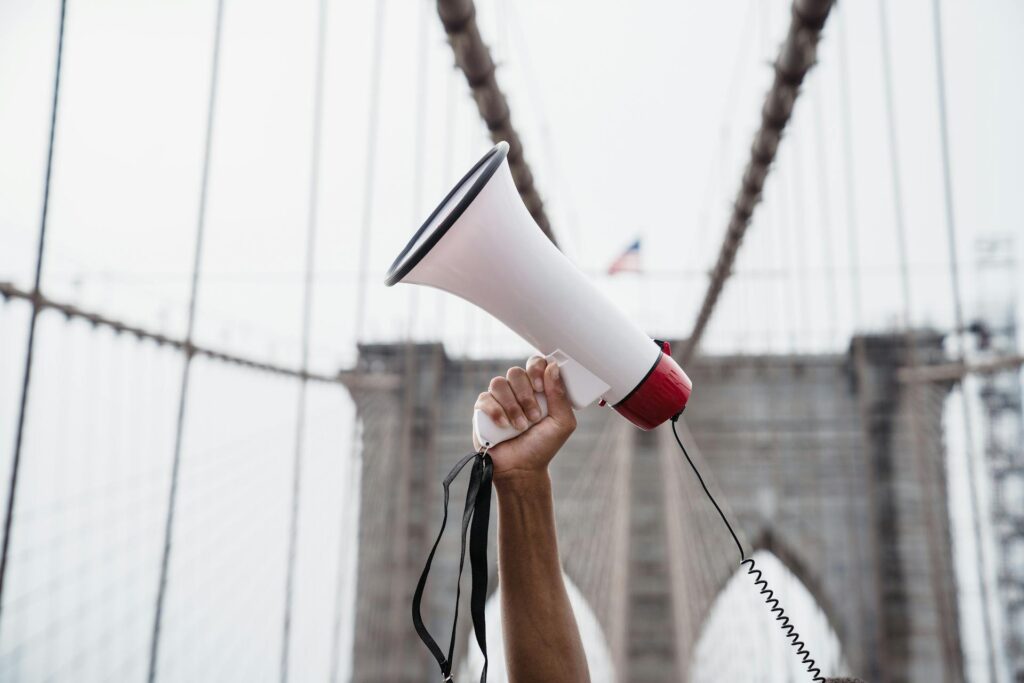 A man holding a megaphone up.